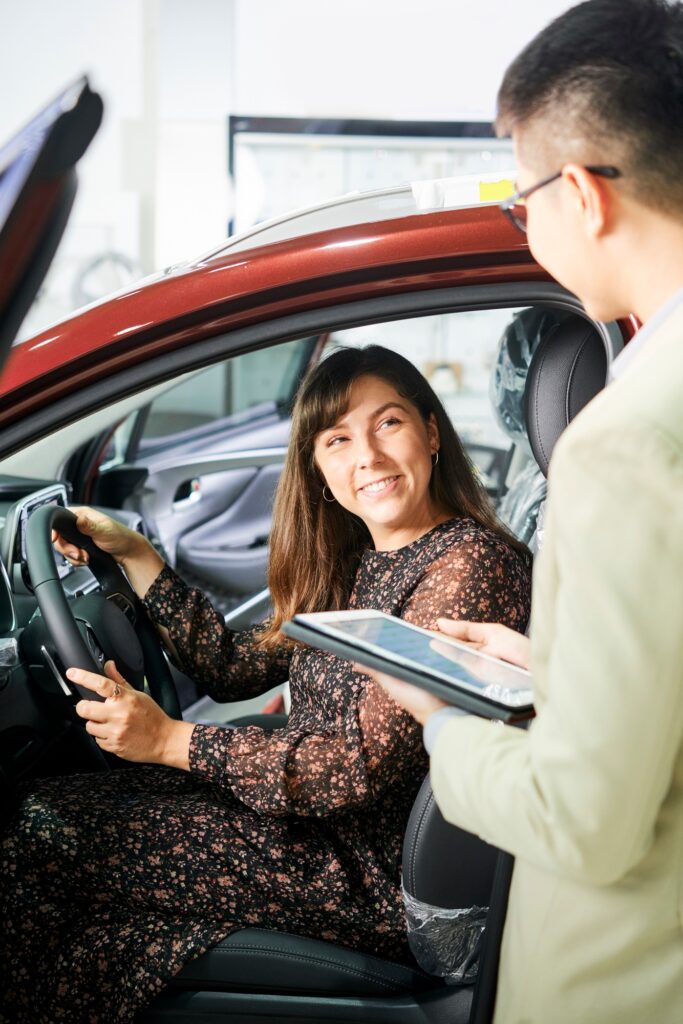Woman and salesman in car showroom